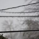 Power lines covered in ice after a winter storm that caused power outage