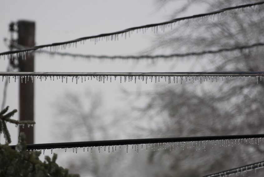 Power lines covered in ice after a winter storm that caused power outage 